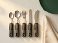 The Everhold Dining Set — five-piece weighted easy-grip cutlery on cream linen